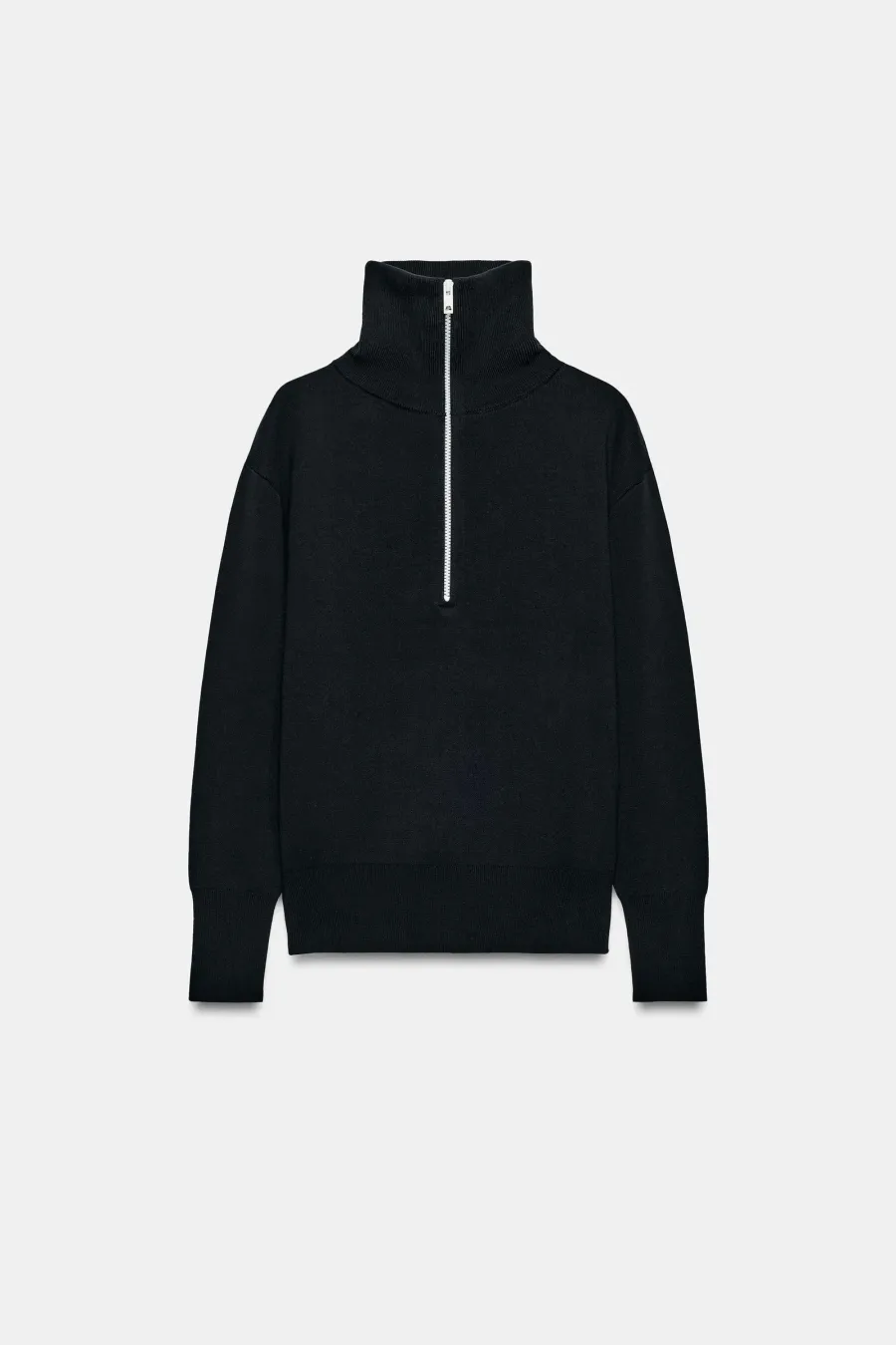 Finished flat lay of the black half-zip knit, revealed
