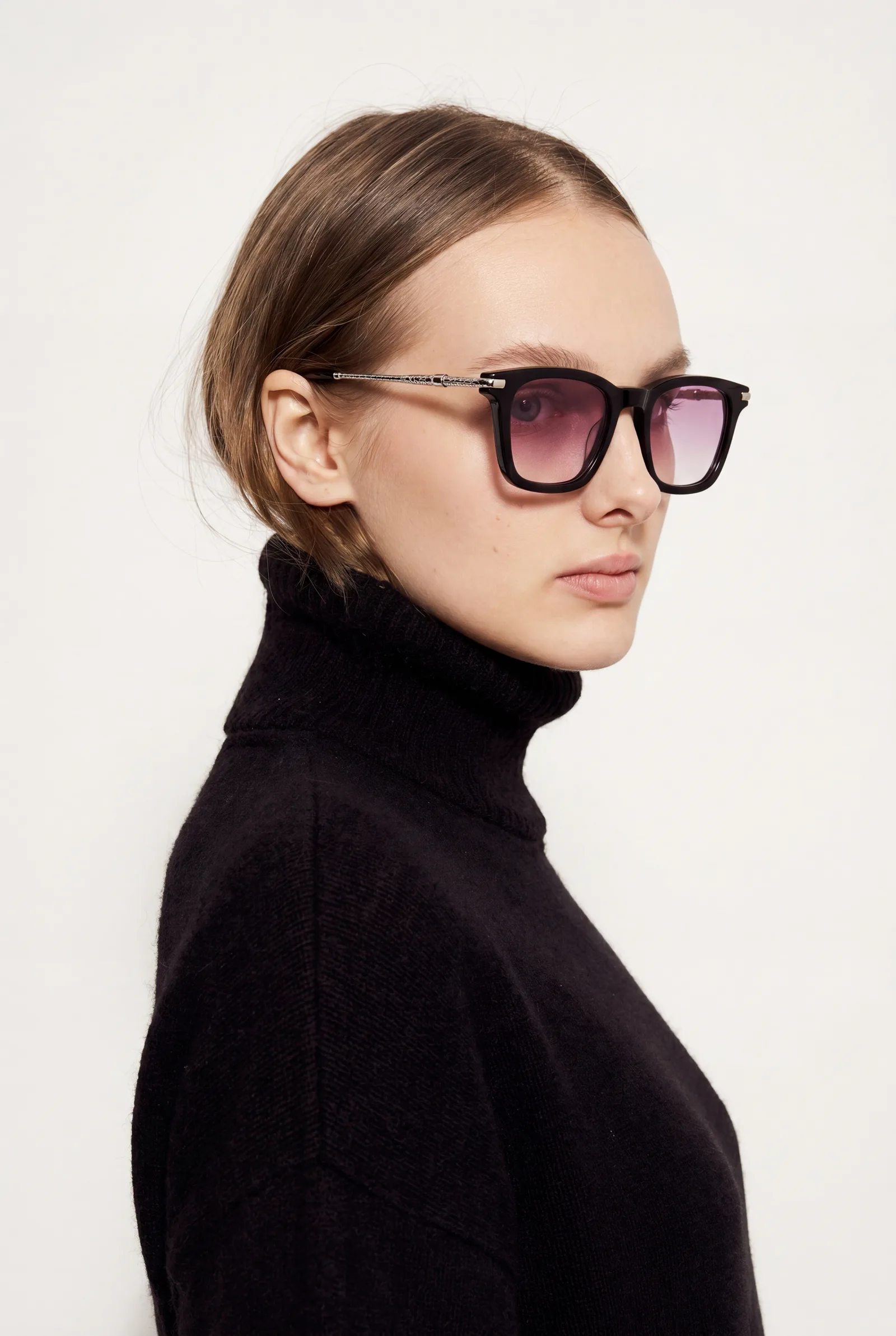 Model in a black turtleneck in side profile wearing the square-frame sunglasses