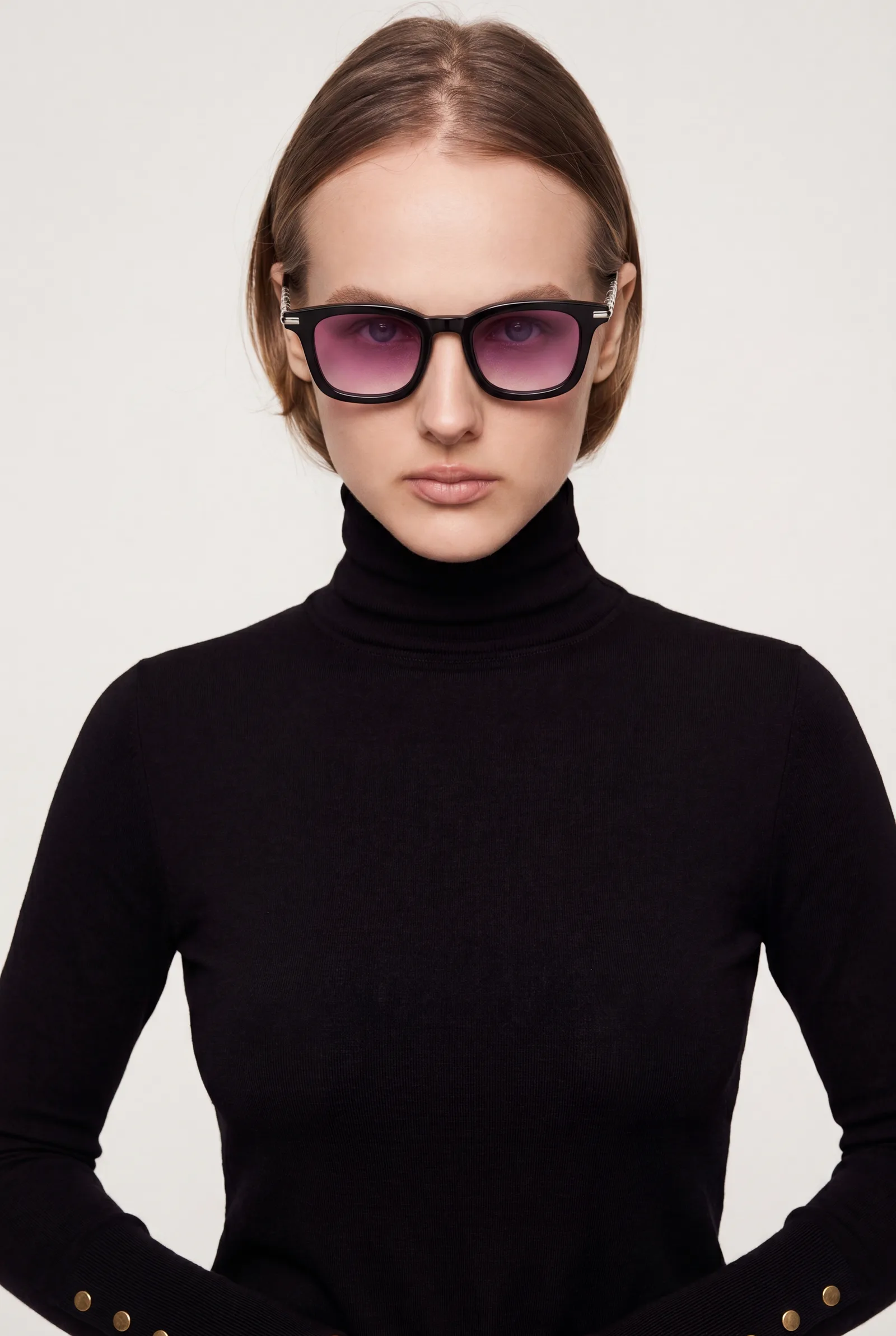 Model in a black turtleneck facing forward wearing the pink-gradient sunglasses