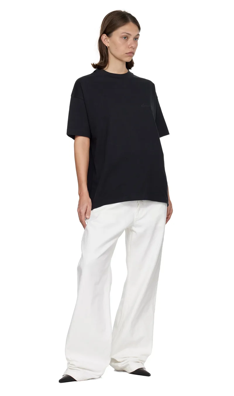 Taliya-produced image of the model in the black tee and white trousers, integrated as the fourth product of the grid